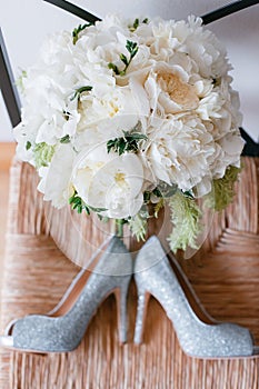 wedding shoes and bouquet of white Garden rose peony