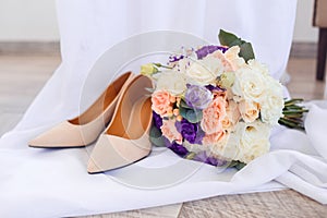 Wedding shoes and a delicate wedding bouquet. Wedding flowers.