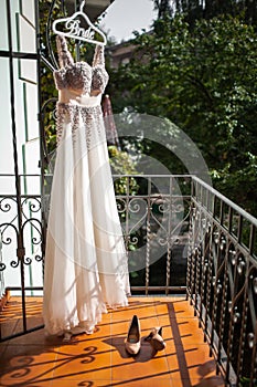 Wedding shoes and dress on the balcony