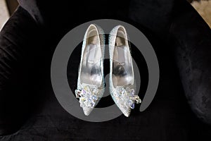 Wedding shoes with gems on a black chair