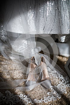 Wedding shoes stand next to the dress