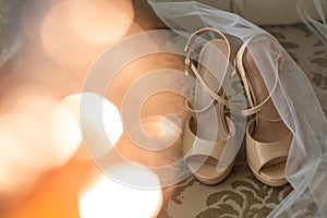 Wedding shoes and veil on wooden floor