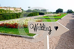 Wedding sign on wooden arrow in park