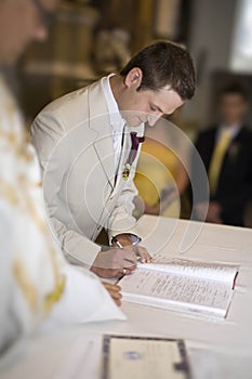 The wedding signature. Groom signing the register