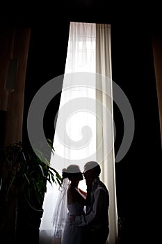Wedding silhouette on a background a window