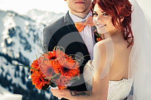 Wedding snowboarders couple just married at mountain winter