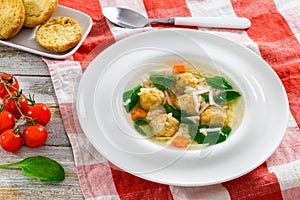 wedding soup with meatballs, small pasta risini,spinach and vegetable