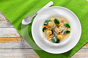 wedding soup with meatballs, small pasta risini,spinach and vegetables