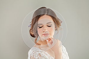 Wedding style. Beautiful young bride with luxury wedding hairstyle and natural fresh makeup portrait