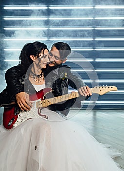 Wedding in the style of rock. Rocker or Biker wedding. Guys with stylish leather jackets. It`s a rocknroll baby. Sweet