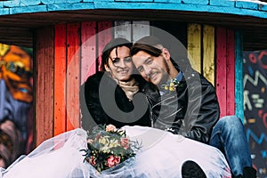 Wedding in the style of rock. Rocker or Biker wedding. Guys with stylish leather jackets. It`s a rocknroll baby. A sweet