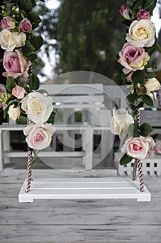 Wedding swing decorated with rose flowers