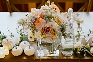 Wedding table with candles and floral centerpieces, adorned with beautiful flowers