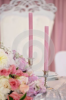 Wedding table with candles, flowers and sign number