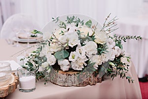 Wedding table decorated with bouquet and candles