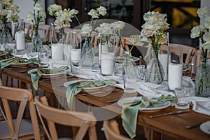 The wedding table decorated with fresh flowers.