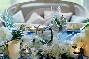 Wedding table decorated with white flowers, candles.. Blue and white. photo