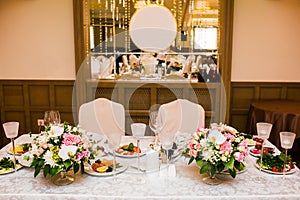 Wedding table decorations on banquet with flowers