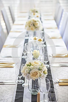Wedding table with flowers and decorations, wedding centerpiece or event reception in modern style
