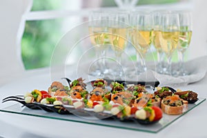 Wedding Table With Food. Appetizer on the Table. Fish and Raw Meat with Vegetables. Champagne Glass in Background.
