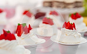 Wedding Table with Mini Cakes with Strawberry on the Top.