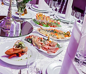 Wedding table served with tasty meals, antipasto platter cold meat, fish platter, cheese platter. Holiday banquet menu