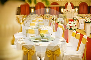 wedding table sets in wedding hall. wedding decorate preparation. table set and another catered event dinner