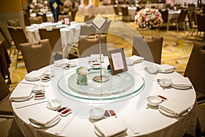 Wedding table sets in wedding hall. wedding decorate preparation. table set and another catered event dinner