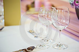 Wedding table setting. Beautiful table set with flowers and glass cups for some festive event, party or wedding reception