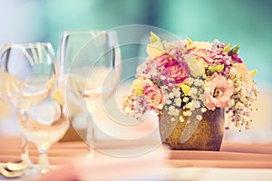 Wedding table setting. Beautiful table set with flowers and glass cups for some festive event, party or wedding reception