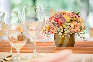 Wedding table setting. Beautiful table set with flowers and glass cups for some festive event, party or wedding reception