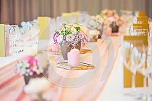 Wedding table setting. Beautiful table set with flowers and glass cups for some festive event, party or wedding reception