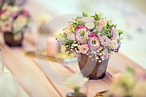 Wedding table setting. Beautiful table set with flowers and glass cups for some festive event, party or wedding reception