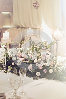 Wedding table setting with classic chairs, elegant floristics decoration in banquet restoraunt. The floral composition