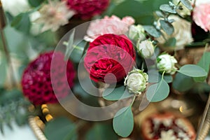 The wedding table setting is decorated with fresh flowers in a brass bowl and golden candles in brass candlesticks. Wedding