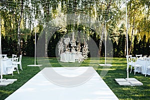 Wedding table setting for newlyweds. Festive table decorated with white plates and napkins.