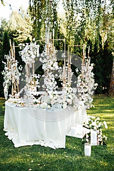 Wedding table setting for newlyweds. Festive table decorated with white plates and napkins.