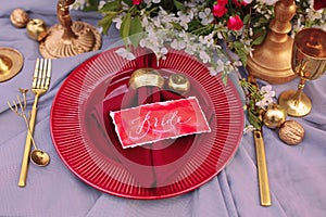 Wedding table setting in red and gold color