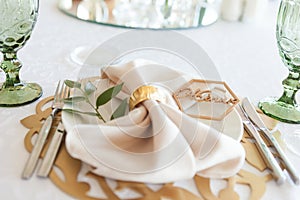 Wedding table setting, tableware for the newlyweds, on a plate a napkin and a rustic sign word - bride or groom