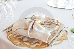 Wedding table setting, tableware for the newlyweds, on a plate a napkin and a rustic sign word - bride or groom