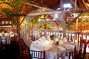 Wedding tables inside a rustic barn photo