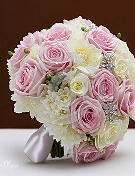 Wedding Theme, Beautiful colorful wedding posy with pink, yellow and white roses with silver decoration and green foliage