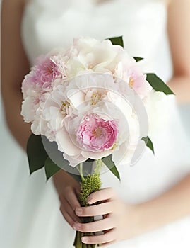 Wedding Theme, Bride holding beautiful wedding posy with delicate pink, lite pink, and white flowers and green foliage