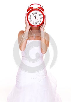 Wedding Time. Portrait bride with clock covering her face.