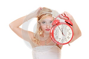 Wedding. Time to get married. Bride with alarm clock.