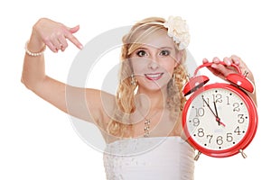 Wedding. Time to get married. Bride with alarm clock.