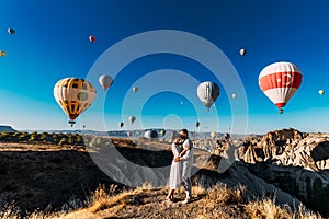 Wedding travel. Honeymoon trip. Couple in love among balloons. A guy proposes to a girl. Couple in love in Cappadocia. Couple in