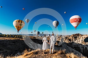 Wedding travel. Honeymoon trip. Couple in love among balloons. A guy proposes to a girl. Couple in love in Cappadocia. Couple in
