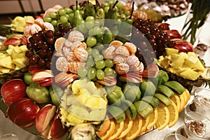 Wedding various fresh fruits and berries with tasty colour on a buffet table, a pile of fruit on a tray