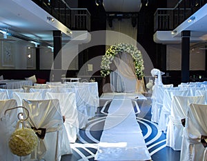 Wedding venue with decorated chairs and altar